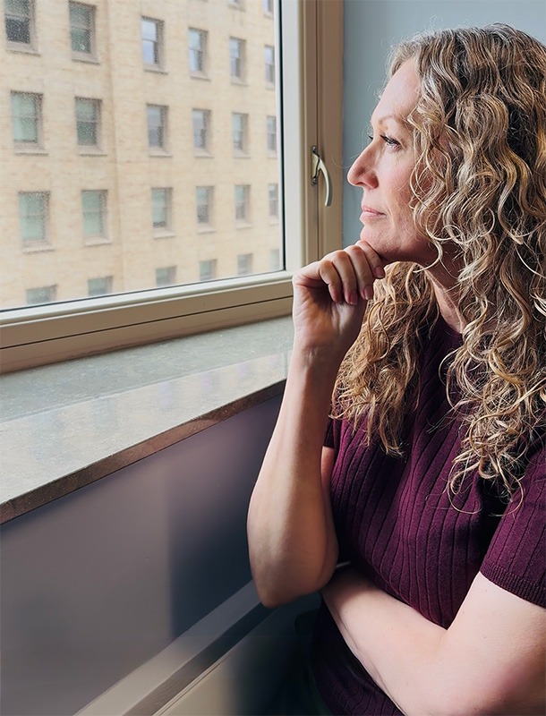 Holly Toscanini looking outside the window