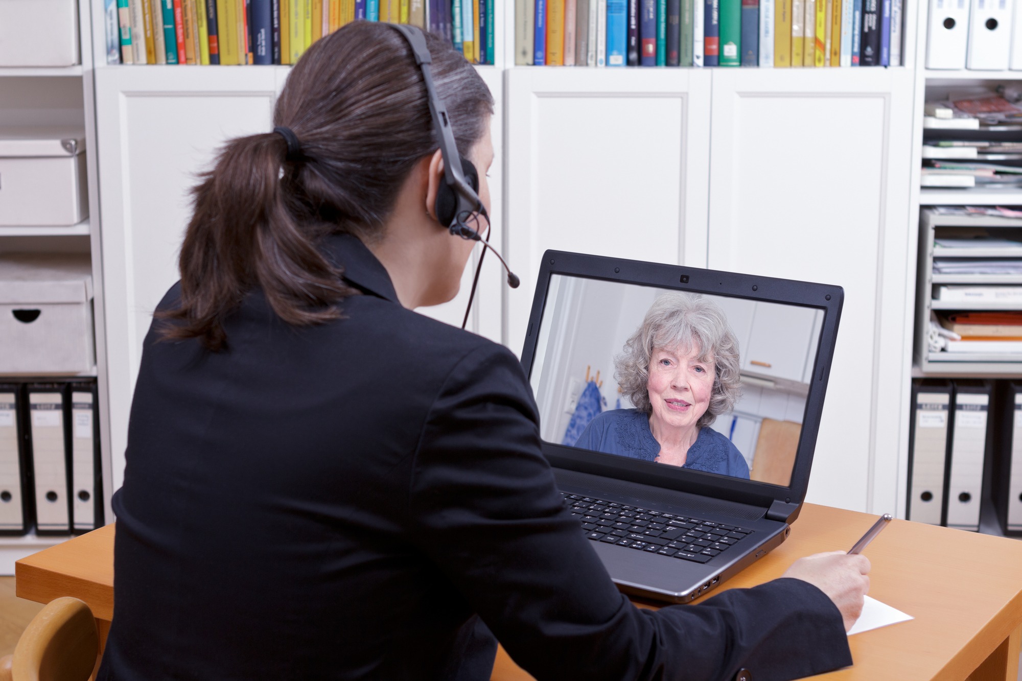 Woman having a live video chat with an elderly woman