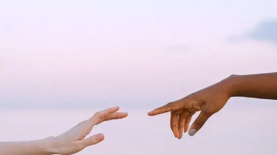photo of people reaching each other s hands